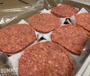 Photo of some burgers lined in a box after being formed at Summit Meats in Saskatoon