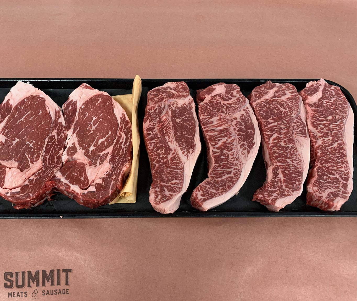 Photo of some Tajima Wagyu steaks from Summit Meats sitting on a tray atop some meat wrapping paper